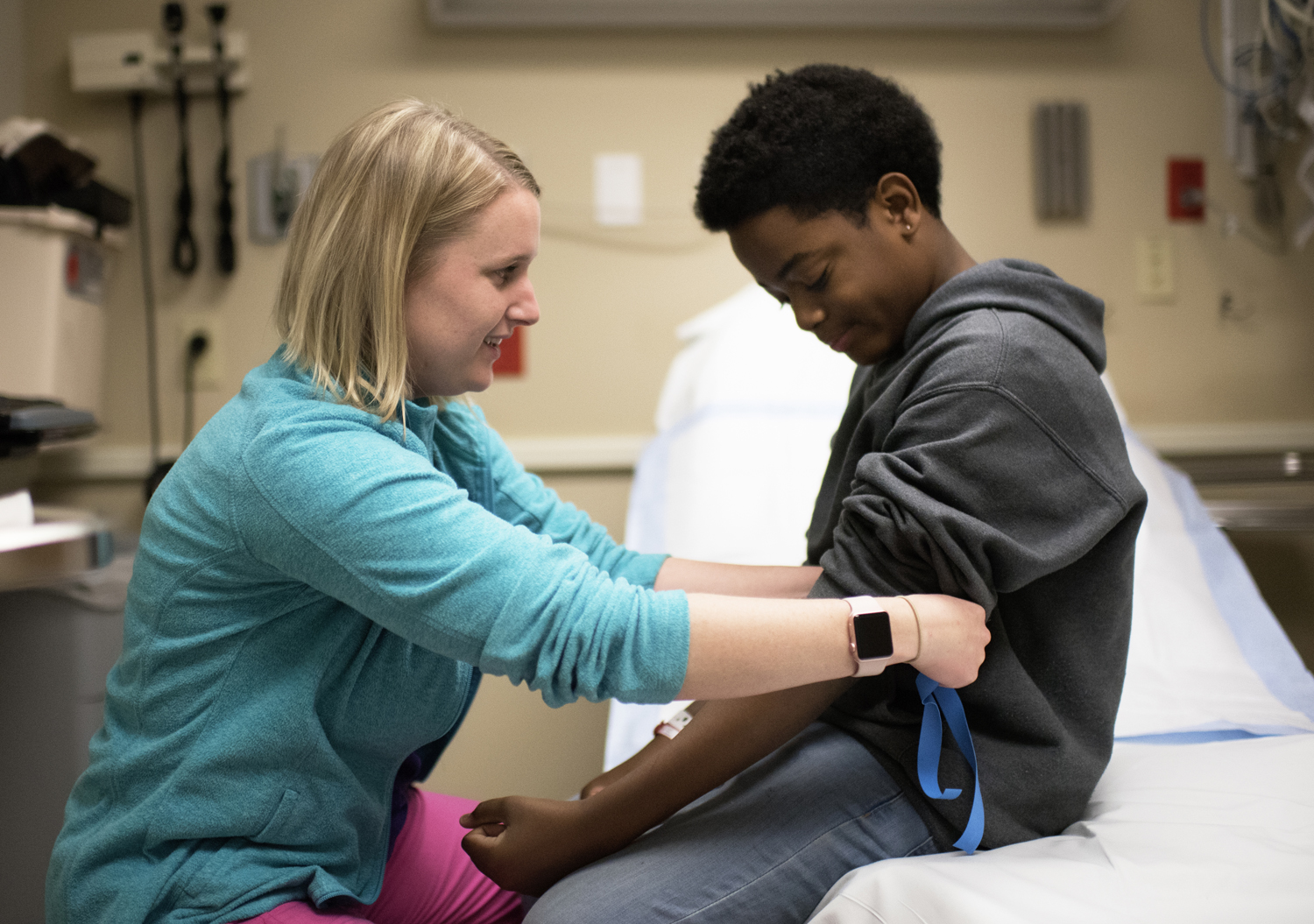 CHKD nurse treating young boy with sickle cell disease.