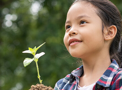 Asian girl holding a plant sprout