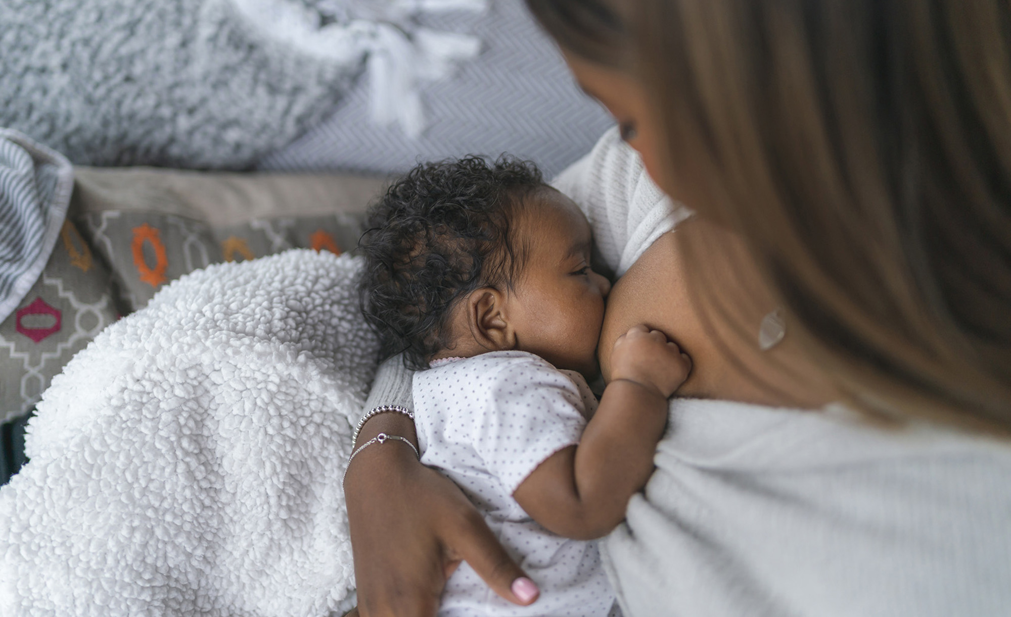 A woman breastfeeding her baby daughter. 