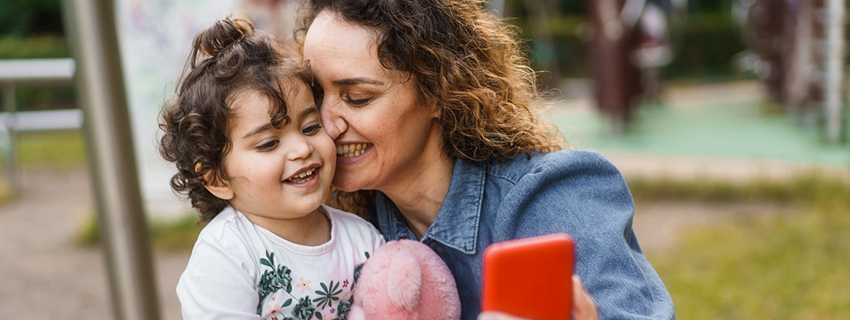 Grandmother takes selfie with child. 