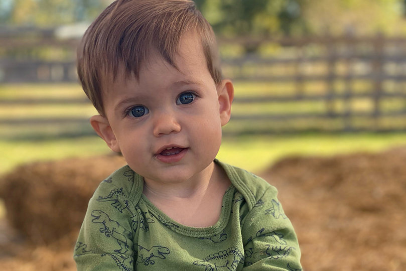 Oakley at about 2 years old playing in a hay field.