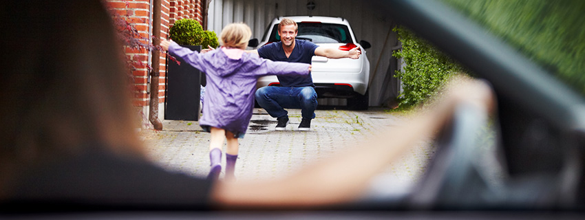 Girl gets out of mom's car and runs to hug dad.