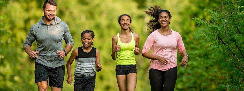 Mixed race family going on a run together.